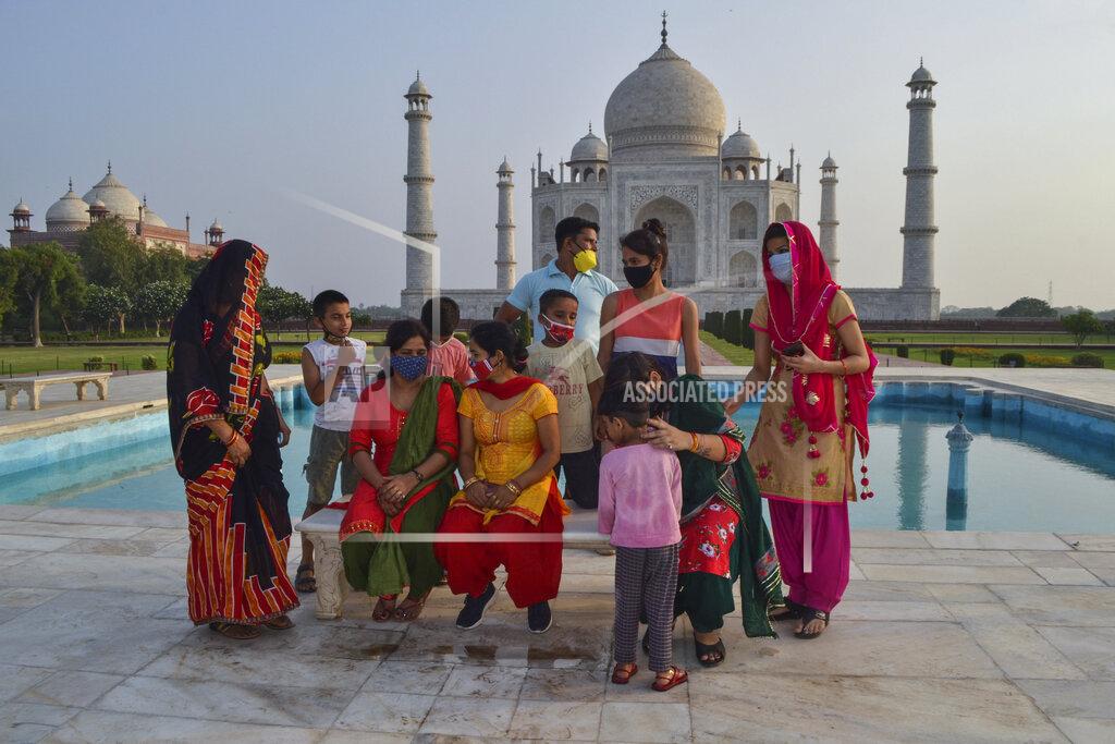 Uncredited A group of Indians who visited the Taj Mahal monument that was Wednesday reopened to public after the lockdown to curb the spread of coronavirus gather to get photographed in Agra, India, Wednesday, June 16, 2021. (AP Photo)