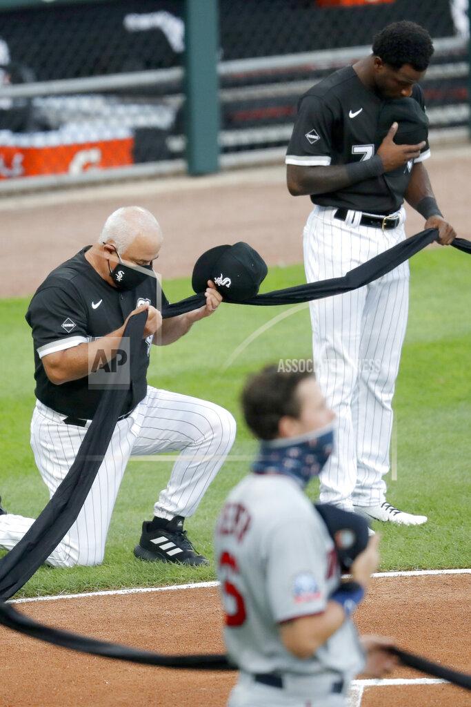 Charles Rex Arbogast Chicago White Sox manager Ricky Renteria kneels for social justice next to Tim Anderson before a baseball game against the Minnesota Twins, Friday, July 24, 2020, in Chicago. (AP Photo/Charles Rex Arbogast)