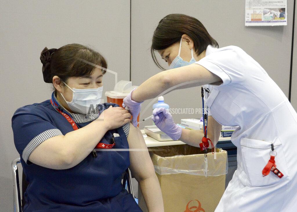 Uncredited A nurse receives the first dose of the Pfizer COVID-19 vaccine at Fujita Health University Hospital in Toyoake, Aichi prefecture, central Japan, on March 8, 2021. Some nurses in Japan are incensed at a request from Tokyo Olympic organizers to have 500 of them dispatched to help out with the games. They say they’re already near the breaking point dealing with the coronavirus pandemic. (Kyodo News via AP)