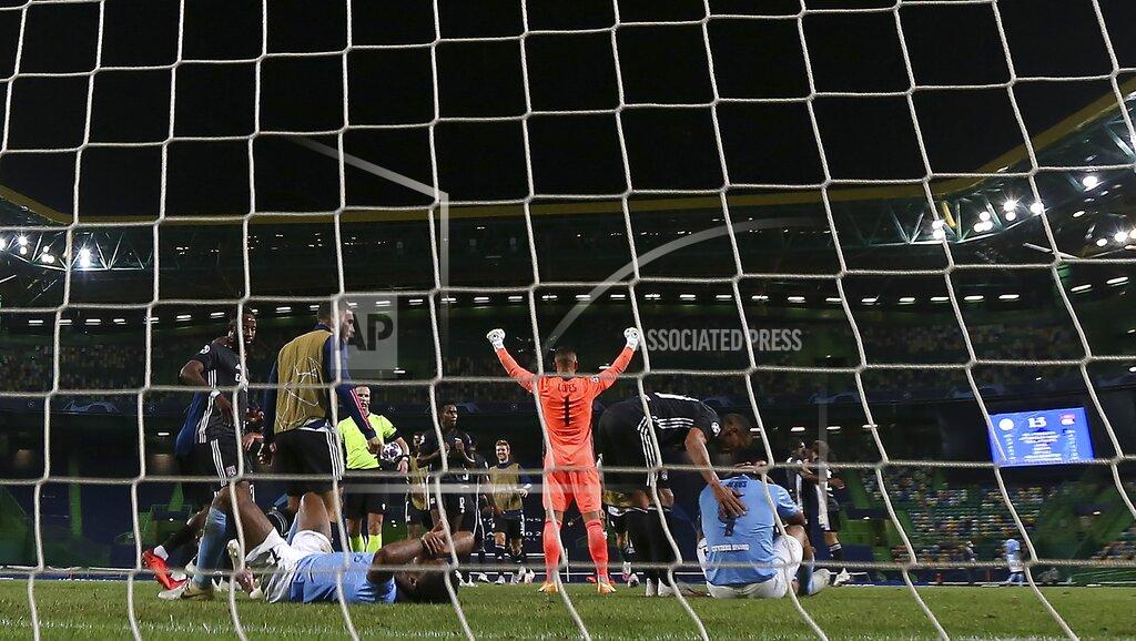 Miguel A. Lopes Lyon's goalkeeper Anthony Lopes celebrates Manchester City's Gabriel Jesus, right, and Manchester City's Raheem Sterling react at the end of the Champions League quarterfinal soccer match between Lyon and Manchester City at the Jose Alvalade stadium in Lisbon, Portugal, Saturday, Aug. 15, 2020. Lyon won the match 3-1. (Miguel A. Lopes/Pool via AP)