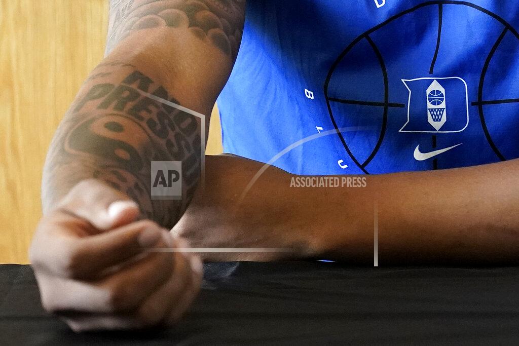 Gerry Broome Duke forward Paolo Banchero shows his "Know Pressure" tattoo as he speaks to reporters during the team's NCAA college basketball media day in Durham, N.C., Tuesday, Sept. 28, 2021. (AP Photo/Gerry Broome)