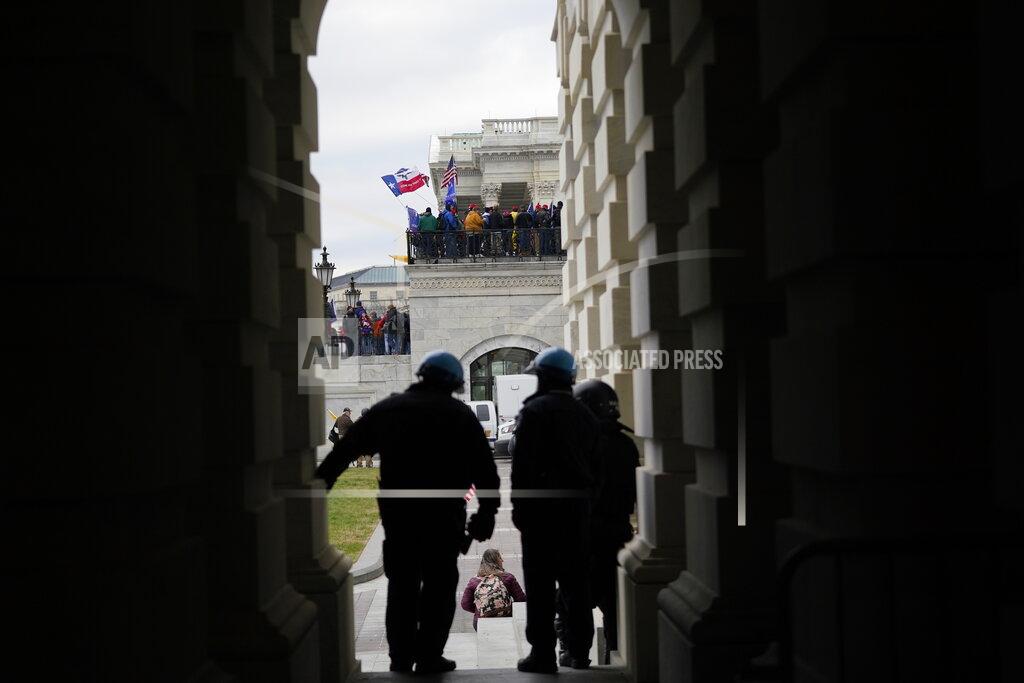 Manuel Balce Ceneta FILE - In this Jan. 6, 2021, file photo rioters gather outside the Capitol in Washington. When President-elect Joe Biden takes office later this month, his biggest challenge may be navigating a deeply divided country past the turmoil of the Trump era. (AP Photo/Manuel Balce Ceneta, File)