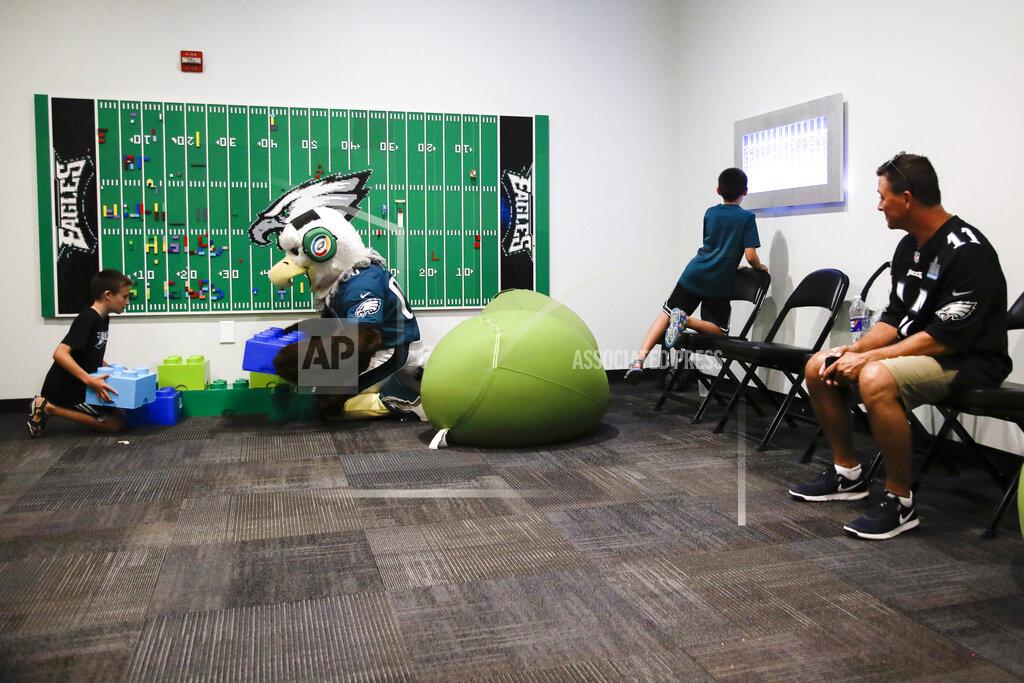 Matt Rourke In this Thursday, Aug. 22, 2019, photo, Victor Ykoruk, right, watches as his 10-year-old twin sons, Ryan, left, and Jack, play in the Lincoln Financial Field sensory room, before a preseason NFL football game between the Philadelphia Eagles and the Baltimore Ravens in Philadelphia. The Eagles partnered with Children's Hospital of Philadelphia and nonprofit KultureCity in the offseason to build a state-of-the-art sensory room on a suites level inside the Linc to accommodate fans and families managing sensory challenges. (AP Photo/Matt Rourke)