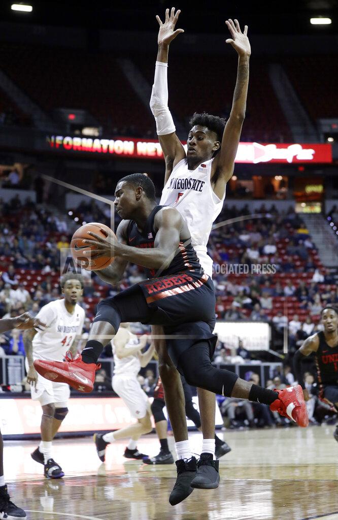 Isaac Brekken San Diego State's Jalen McDaniels defends as UNLV's Amauri Hardy drives to the basket during the second half of an NCAA college basketball game in the Mountain West Conference men's tournament Thursday, March 14, 2019, in Las Vegas. (AP Photo/Isaac Brekken)