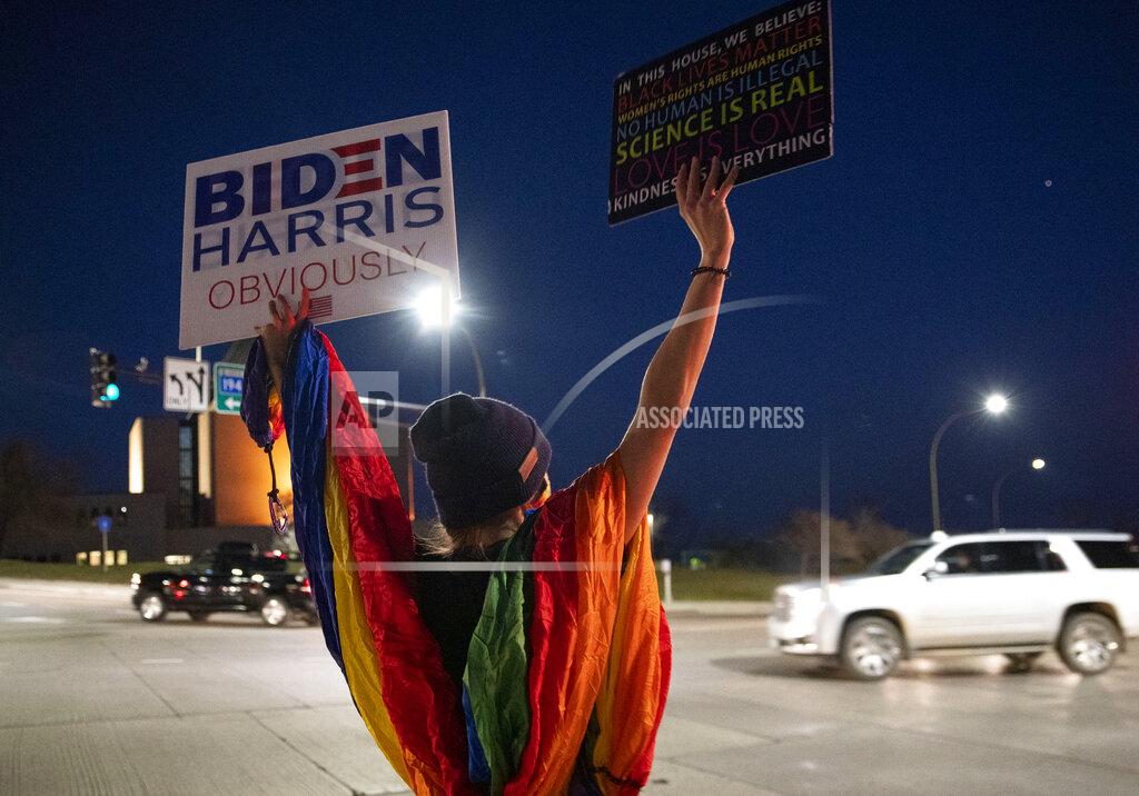 Alex Kormann Allisun Zagar joined around thirty-five Biden supporters as they gathered at the intersection of Central Entrance and Mesaba Ave. in Duluth, Minn., on Tuesday, Nov. 3, 2020. (Alex Kormann/Star Tribune via AP)