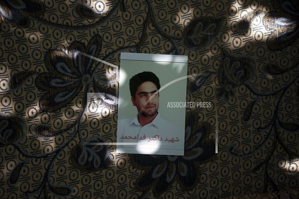 Felipe Dana A portrait of Fida Mohammad, a 24-year-old dentist, who died after falling from a departing U.S. Air Force C-17 on Aug. 16, hangs in his family house in Kabul, Afghanistan, Friday, Sept. 17, 2021. (AP Photo/Felipe Dana)