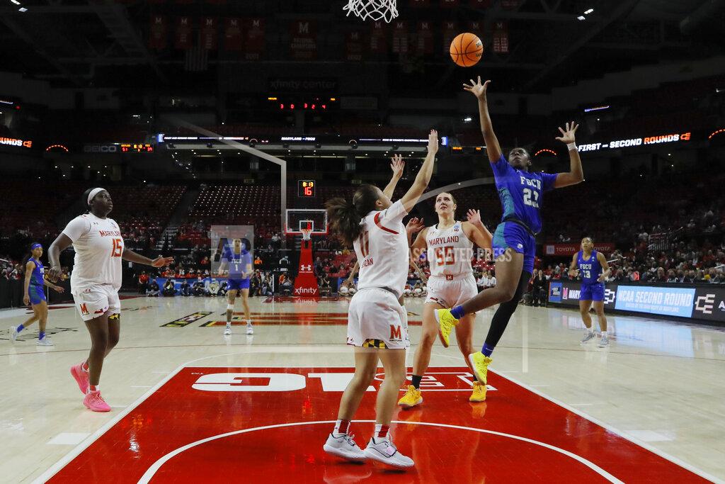 Julio Cortez Florida Gulf Coast guard Karli Seay (23) goes up for a shot against Maryland guard Katie Benzan (11), forward Chloe Bibby (55) and guard Ashley Owusu (15) during the second half of a college basketball game in the second round of the NCAA tournament, Sunday, March 20, 2022, in College Park, Md. Maryland won 89-65. (AP Photo/Julio Cortez)