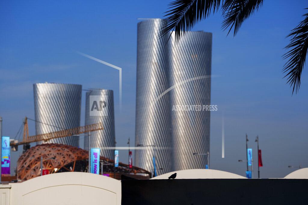 Pavel Golovkin A bird sits on a fence with the Lusail plaza towers in the background in Lusail downtown, Qatar, Thursday, Nov. 24, 2022. (AP Photo/Pavel Golovkin)