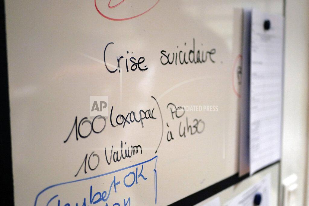 Thibault Camus A board reads 'suicidal crisis' in the emergency ward of the Rouvray psychiatric hospital, in Rouen, western France, Wednesday, Nov. 25, 2020. Lockdowns that France has used to fight the coronavirus have come at considerable cost to mental health. Surveying points to a surge of depression most acute among people without work, in financial hardship and young adults. (AP Photo/Thibault Camus)