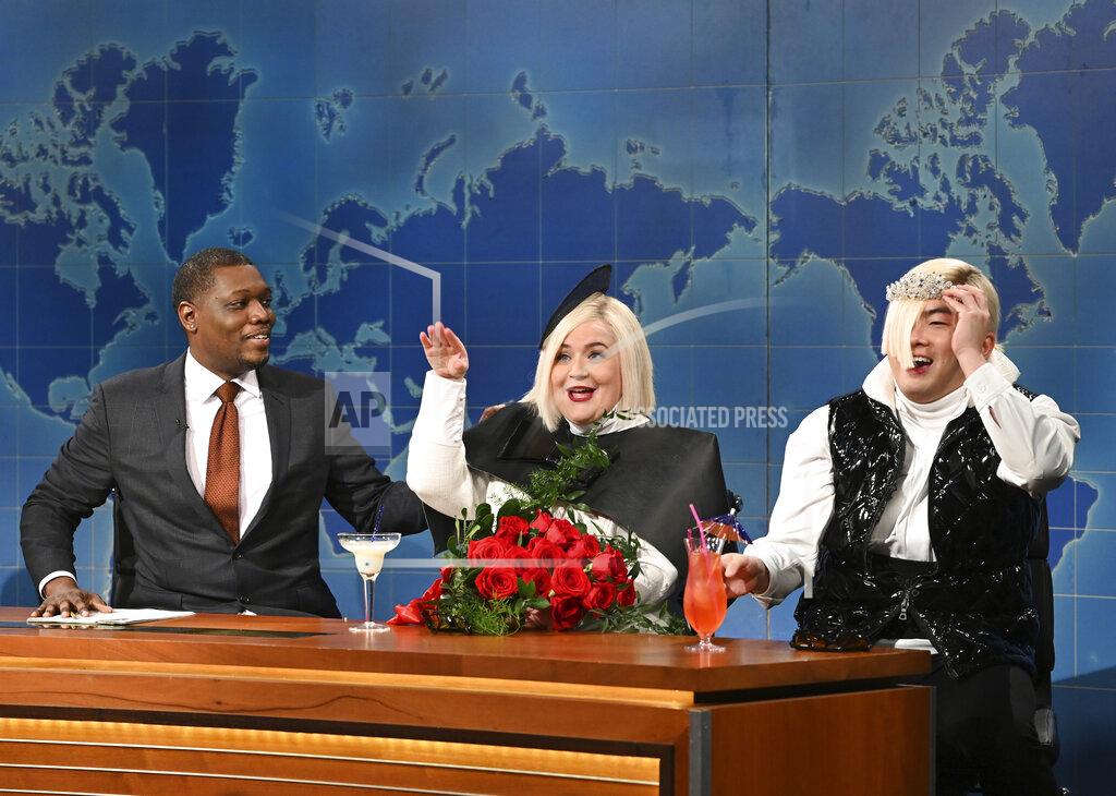 Will Heath This image released by NBC shows Michael Che, left, with Aidy Bryant, center, and Bowen Yang during the "Weekend Update" segment on "Saturday Night Live" in New York on May 21, 2022. (Will Heath/NBC via AP)