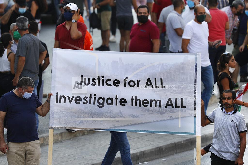 Hussein Malla FILE - In this Aug. 31, 2020 file photo, Lebanese supporters of President Michel Aoun hold a banner during a protest calling for "truth and justice" in relation to the Aug. 4 explosion that devastated Beirut port and parts of the Lebanese capital, in Beirut, Lebanon. A public feud in recent weeks among prosecutors has starkly demonstrated how Lebanon's system of sectarian factions is paralyzing Lebanon's judicial system and snarling attempts to root out corruption. (AP Photo/Hussein Malla, File)