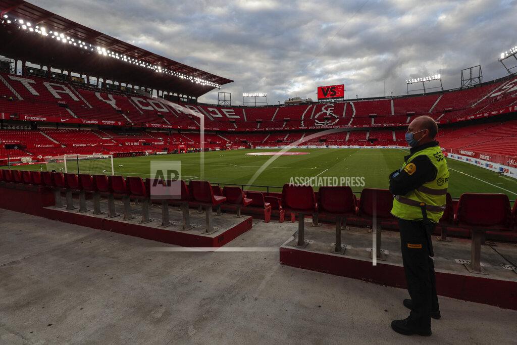 Str A steward watches from the empty stands before the start of the Spanish La Liga soccer match between Sevilla and Betis in Seville, Spain, Thursday, June 11, 2020. With virtual crowds, daily matches and lots of testing for the coronavirus, soccer is coming back to Spain. The Spanish league resumes this week more than three months after it was suspended because of the pandemic, becoming the second top league to restart in Europe. The Bundesliga was first. The Premier League and the Italian league should be next in the coming weeks. (AP Photo)