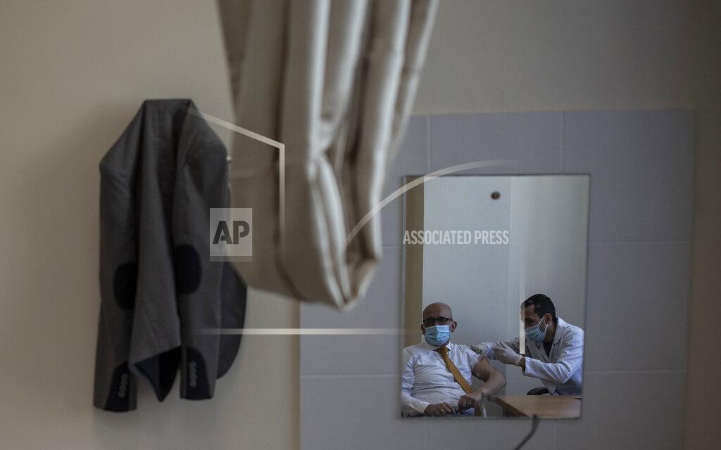 Khalil Hamra A Palestinian man receives a shot of the Russian-made Sputnik V coronavirus vaccine, at an UNRWA clinic in Gaza City, Wednesday, March 17, 2021. The Palestinian Authority says it will receive 62,000 coronavirus vaccine doses through a World Health Organization partnership designed to help poor countries. (AP Photo/Khalil Hamra)