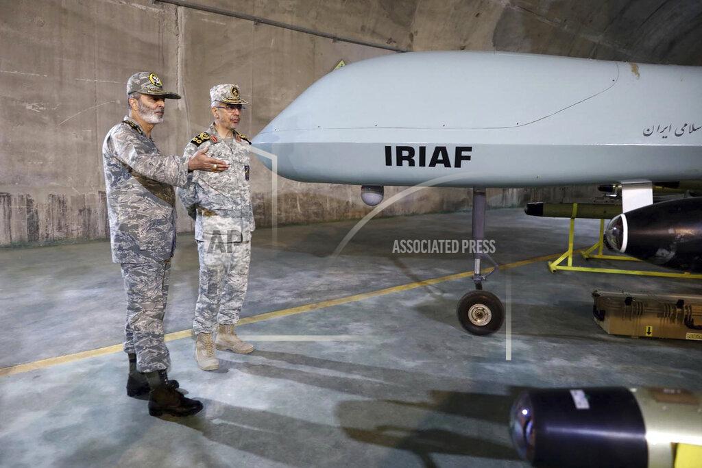 Uncredited In this photo released on Saturday, May 28, 2022 by website of the Iranian Army, Chief of the General Staff of the Armed Forces Gen. Mohammad Hossein Bagheri, right, and Commander of the Army Gen. Abdolrahim Mousavi talk while visiting an underground drone base tunnel of the Army in the heart of the country's western Zagros Mountains. Iranian state television's report said Saturday, May 29, the tunnel was some 100 meters (330 feet) underground and was home to the Kaman-22 and Fotros drones, both capable of carrying cruise missiles. (Iranian Army via AP)