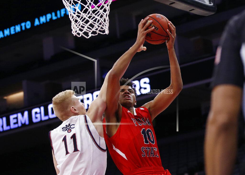Rich Pedroncelli Fresno State forward Orlando Robinson, right, goes to the basket against Saint Mary's forward Matthias Tass during the second half of an NCAA college basketball game in Sacramento, Calif., Wednesday, Nov. 20, 2019. Saint Mary's won 68-58. (AP Photo/Rich Pedroncelli)
