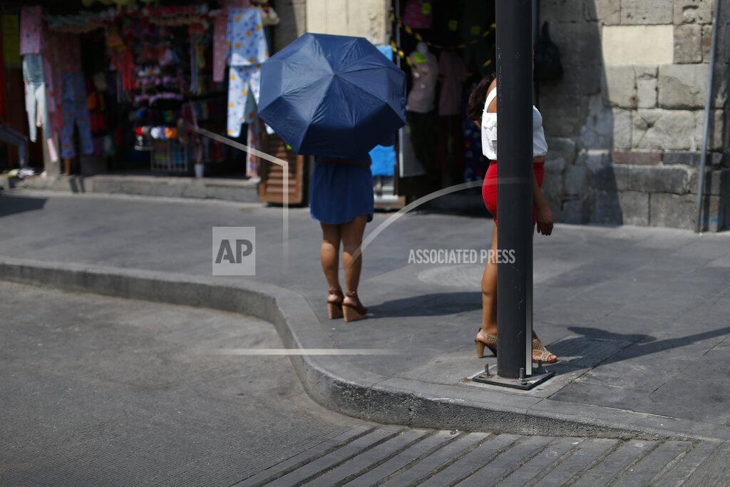 Rebecca Blackwell Sex workers wait for clients on a corner in central Mexico City, Saturday, March 6, 2021. Elvira Madrid, who leads the activist group Brigada Callejera or "The Street Brigade", said that her group found 15,200 sex workers on the city's streets in August 2020, about 40% more than had worked in the trade before the coronavirus pandemic hit. (AP Photo/Rebecca Blackwell)