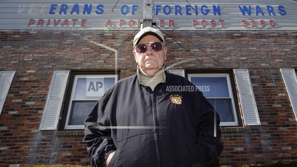 Charles Krupa Paul Guilbeault, quartermaster at Veterans of Foreign Wars Post #3260, poses outside the building former home of the post, Friday, March 12, 2021, in New Bedford, Mass. Guilbeault knew the writing was on the wall for the last Veterans of Foreign Wars post in this city south of Boston when businesses across Massachusetts were ordered to close as the coronavirus pandemic took hold last March. (AP Photo/Charles Krupa)