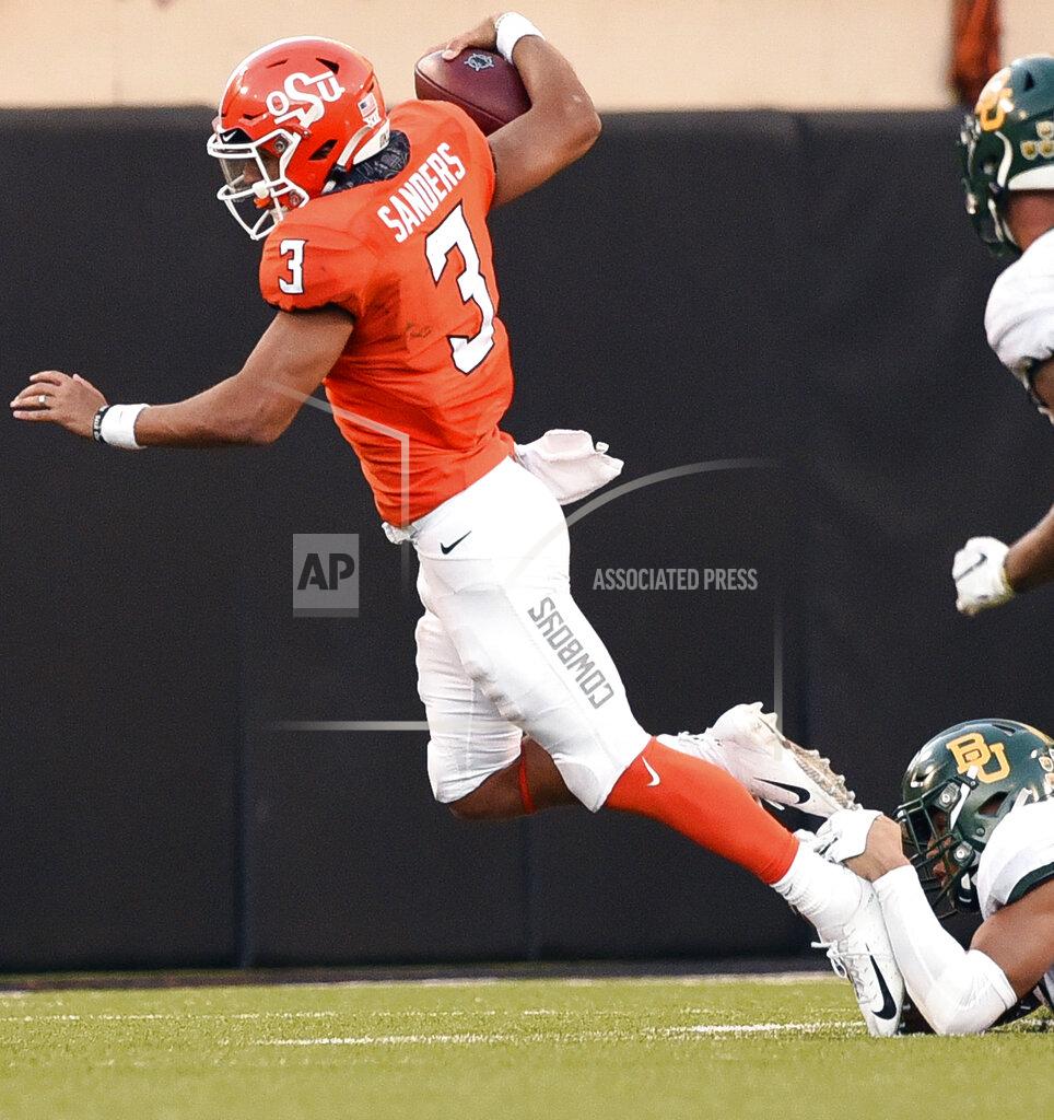 Brody Schmidt Oklahoma State quarterback Spencer Sanders (3) is brought down by the ankle tackle of Baylor linebacker Blake Lynch, bottom right, during the second half of an NCAA college football game in Stillwater, Okla., Saturday, Oct. 19, 2019. (AP Photo/Brody Schmidt)