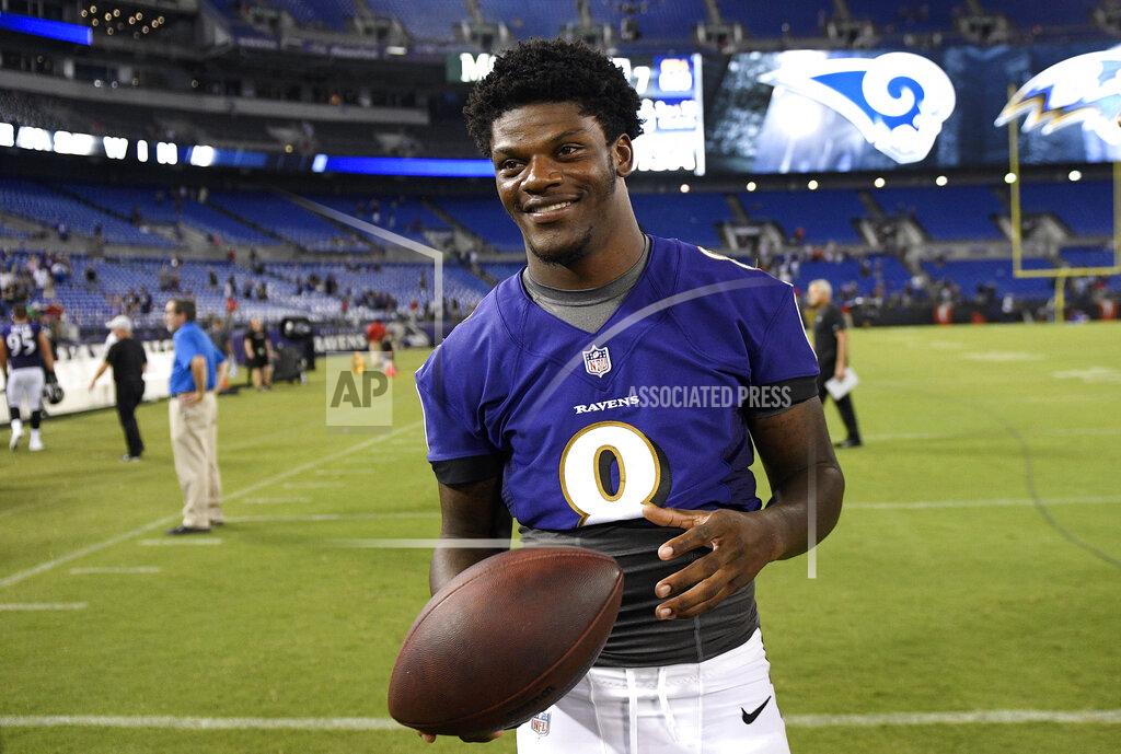 Nick Wass FILE - In this Aug. 9, 2018, file photo, Baltimore Ravens quarterback Lamar Jackson stands on the field after a preseason NFL football game against the Los Angeles Rams, in Baltimore. Jackson will become the first 21-year-old to start at quarterback in an NFL postseason game Sunday, Jan. 9, 2019, when Baltimore hosts the Los Angeles Chargers. (AP Photo/Nick Wass, File)