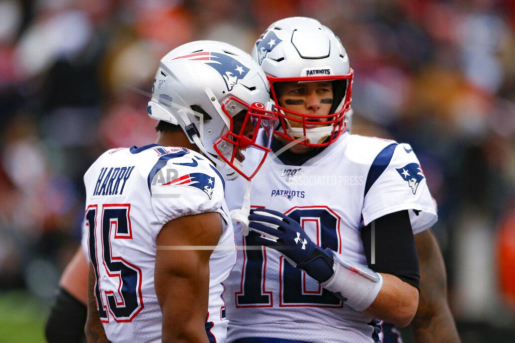 Gary Landers New England Patriots wide receiver N'Keal Harry (15) celebrates his touchdown with quarterback Tom Brady (12) in the second half of an NFL football game against the Cincinnati Bengals, Sunday, Dec. 15, 2019, in Cincinnati. (AP Photo/Gary Landers)
