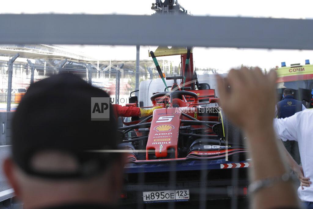 Luca Bruno The racer car of Ferrari driver Sebastian Vettel of Germany is towed by mechanics at pit during the Russian Formula one Grand Prix, at the 'Sochi Autodrom' Formula One circuit, in Sochi, Russia, Sunday, Sept. 29, 2019. (AP Photo/Luca Bruno)