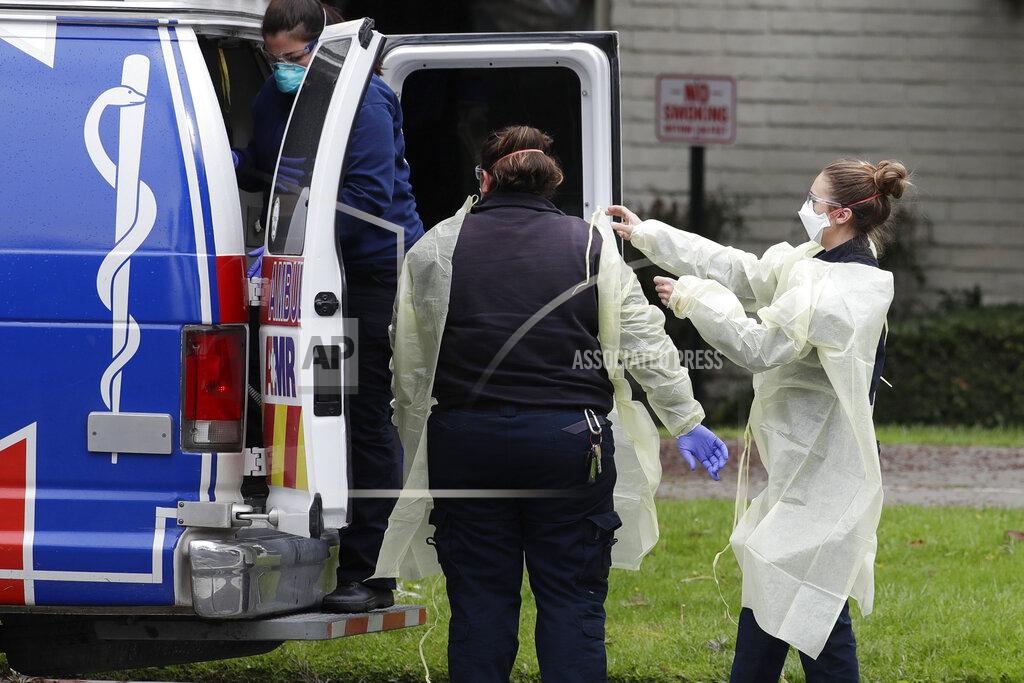 Chris Carlson Ambulance personnel get ready to evacuate patients from the Magnolia Rehabilitation and Nursing Center in Riverside, Calif., Wednesday, April 8, 2020. More than 80 patients from a Riverside skilled nursing facility are being evacuated this morning to other healthcare locations throughout Riverside County, Calif. (AP Photo/Chris Carlson)
