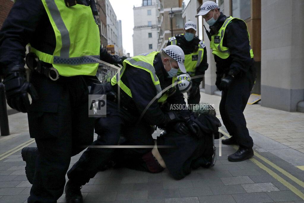 Matt Dunham Police restrain a demonstrator during clashes following a 'Kill the Bill' protest in London, Saturday, April 3, 2021. The demonstration is against the contentious Police, Crime, Sentencing and Courts Bill, which is currently going through Parliament and would give police stronger powers to restrict protests. (AP Photo/Matt Dunham)