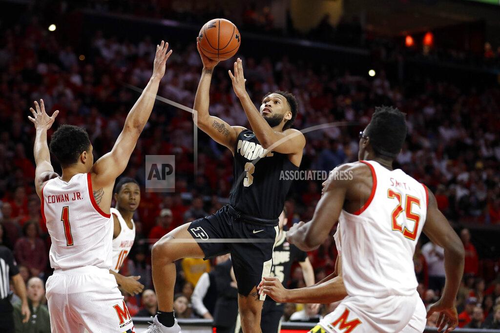 Julio Cortez Purdue guard Jahaad Proctor (3) goes up for a shot against Maryland guard Anthony Cowan Jr. (1) and forward Jalen Smith (25) during the first half of an NCAA college basketball game, Saturday, Jan. 18, 2020, in College Park, Md. (AP Photo/Julio Cortez)