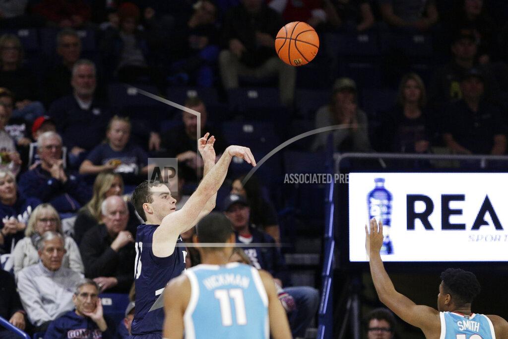 Young Kwak North Florida guard Oscar Berry, left, shoots during the second half of an NCAA college basketball game against Gonzaga, Monday, Nov. 7, 2022, in Spokane, Wash. Gonzaga won 104-63. (AP Photo/Young Kwak)