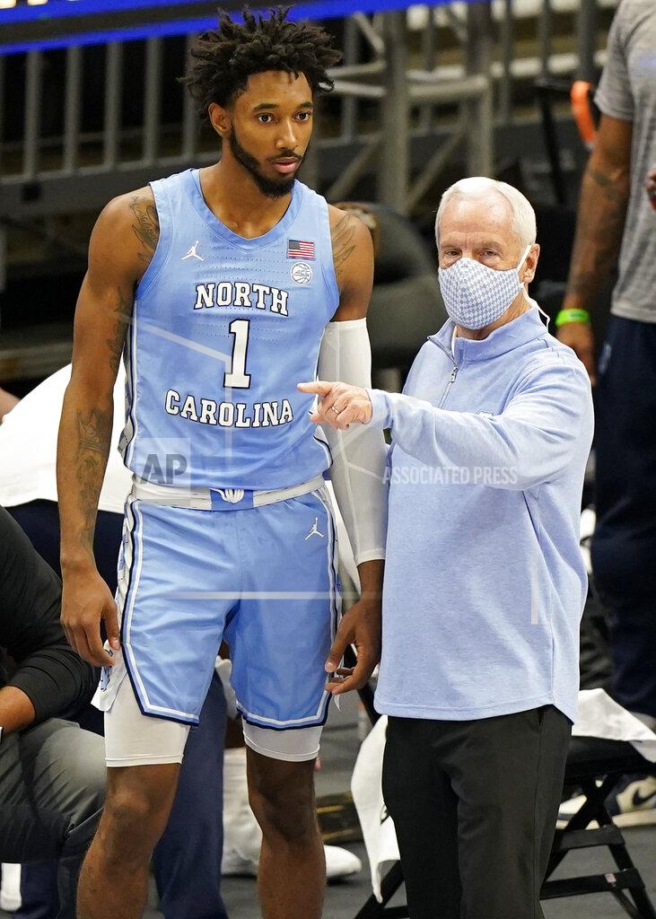 Tony Dejak North Carolina head coach Roy Williams, right, talks with Leaky Black in the first half of an NCAA college basketball game against Kentucky, Saturday, Dec. 19, 2020, in Cleveland. (AP Photo/Tony Dejak)