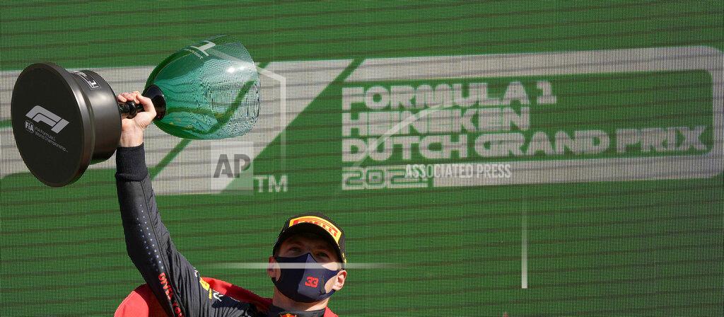 Francisco Seco Red Bull driver Max Verstappen of the Netherlands celebrates on the podium after winning the Formula One Dutch Grand Prix, at the Zandvoort racetrack, Netherlands, Sunday, Sept. 5, 2021. (AP Photo/Francisco Seco)