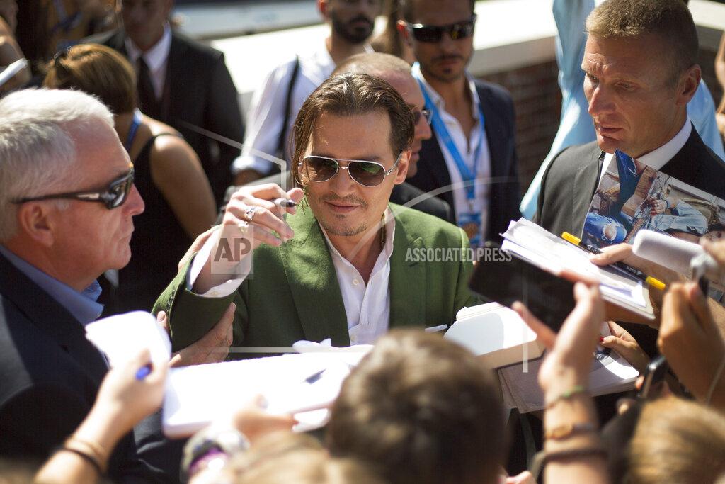Joel Ryan File - Johnny Depp signs autographs for fans as he departs after a photo call for 'Black Mass' at the Venice Film Festival. The 77th Venice Film Festival will kick off on Wednesday, Sept. 2, 2020, but this year's edition will be unlike any others. Coronavirus restrictions will mean fewer Hollywood stars, no crowds interacting with actors and other virus safeguards will be deployed. (Photo by Joel Ryan/Invision/AP, File)