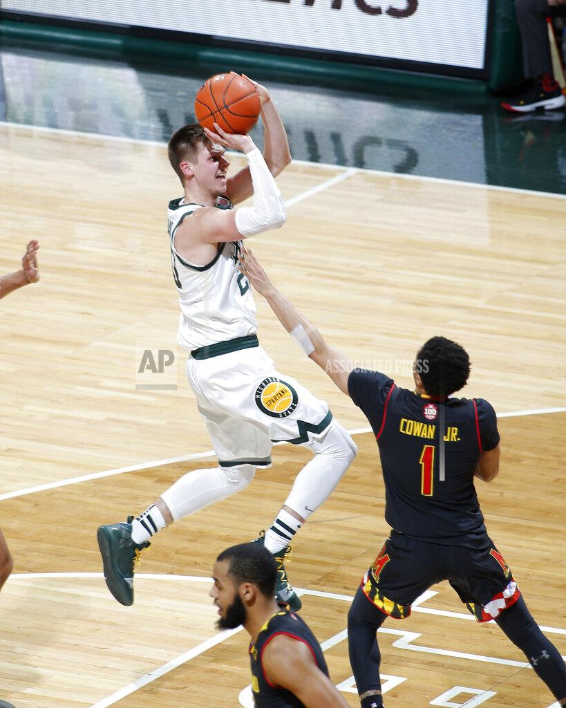 Al Goldis Michigan State's Matt McQuaid, left, shoots against Maryland's Anthony Cowan (1) during the first half of an NCAA college basketball game, Monday, Jan. 21, 2019, in East Lansing, Mich. (AP Photo/Al Goldis)