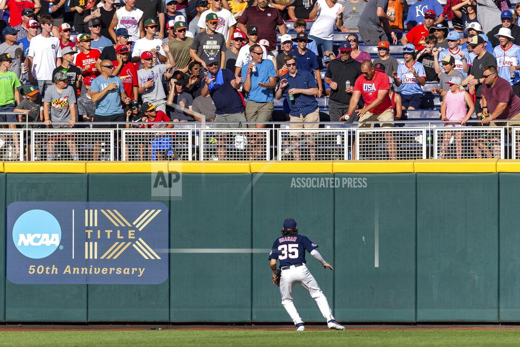 John Peterson Mississippi left fielder Kevin Graham (35) watches the ball go over the wall for a home run by Arkansas' Chris Lanzilli (18) in the second inning during an NCAA College World Series baseball game Wednesday, June 22, 2022, in Omaha, Neb. (AP Photo/John Peterson)