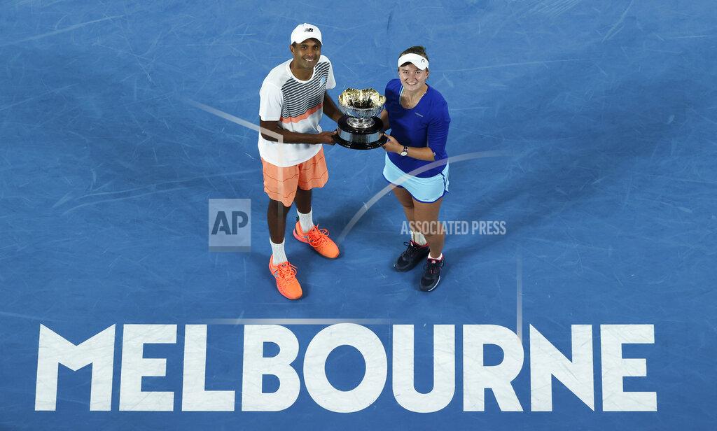Hamish Blair Rajeev Ram of the US and Barbora Krejcikova of the Czech Republic pose with their trophy after defeating Australia's Samantha Stosur and Matthew Ebden in the mixed doubles final at the Australian Open tennis championship in Melbourne, Australia, Saturday, Feb. 20, 2021.(AP Photo/Hamish Blair)