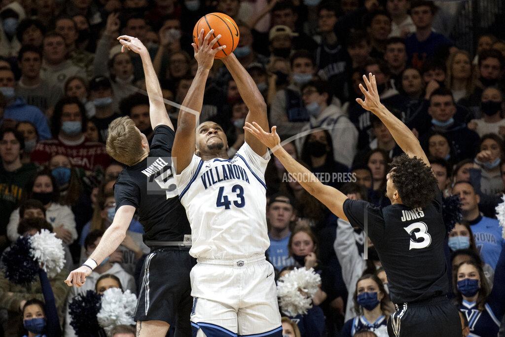 Laurence Kesterson Villanova forward Eric Dixon (43) grabs a rebound away from Xavier's Adam Kunkel (5) and Colby Jones (3) during the first half of an NCAA college basketball game Tuesday, Dec. 21, 2021, in Villanova, Pa. (AP Photo/Laurence Kesterson)