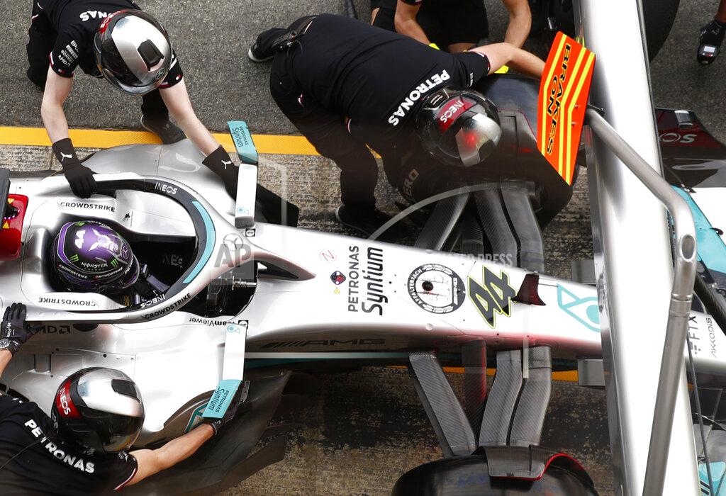 Joan Monfort Mechanics work on the car of Mercedes driver Lewis Hamilton of Britain during a Formula One pre-season testing session at the Catalunya racetrack in Montmelo, just outside of Barcelona, Spain, Friday, Feb. 25, 2022. (AP Photo/Joan Monfort)