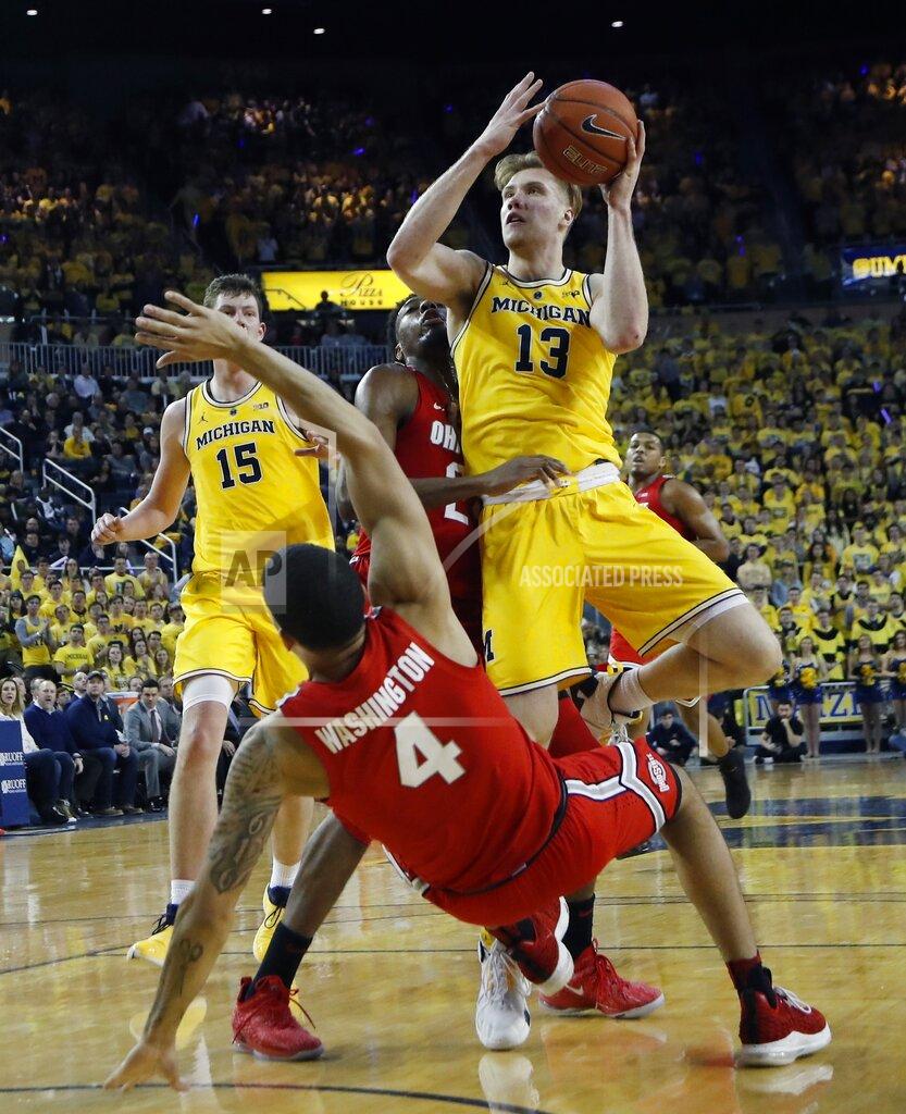 Carlos Osorio Michigan forward Ignas Brazdeikis (13) fouls Ohio State guard Duane Washington Jr. (4) during the second half of an NCAA college basketball game Tuesday, Jan. 29, 2019, in Ann Arbor, Mich. (AP Photo/Carlos Osorio)
