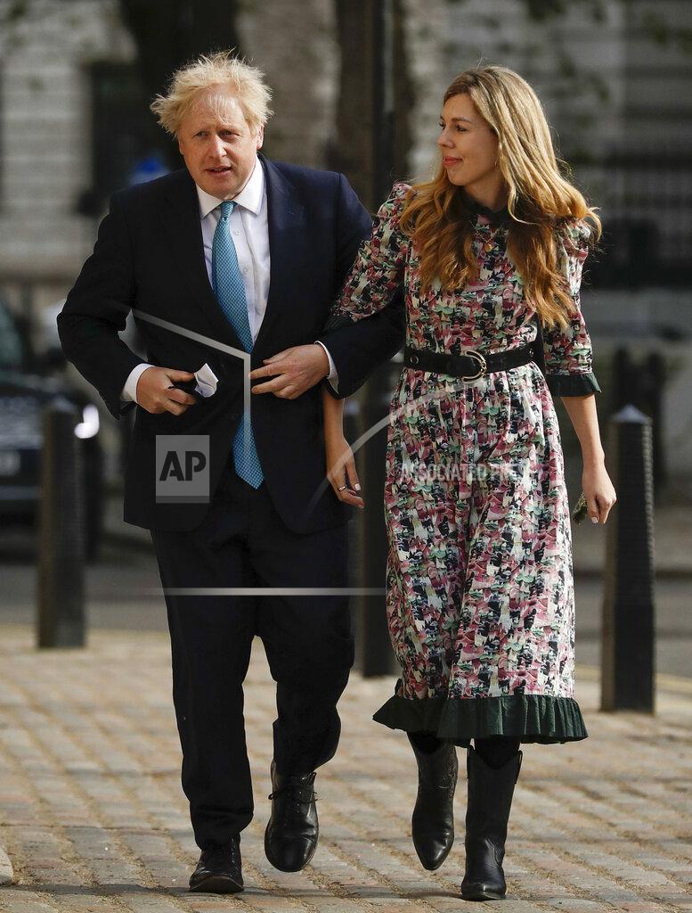 Matt Dunham FILE - In this Thursday May 6, 2021, file photo, British Prime Minister Boris Johnson arrives at a polling station with his partner Carrie Symonds to cast his vote in local council elections in London. U.K. newspapers are reporting that Prime Minister Johnson and his fiancée Symonds married Saturday, May 29, 2021, in a small private ceremony in London. The Mail on Sunday and the Sun said the couple wed at the Roman Catholic Westminster Cathedral in front of a small group of friends and family. (AP Photo/Matt Dunham, File)