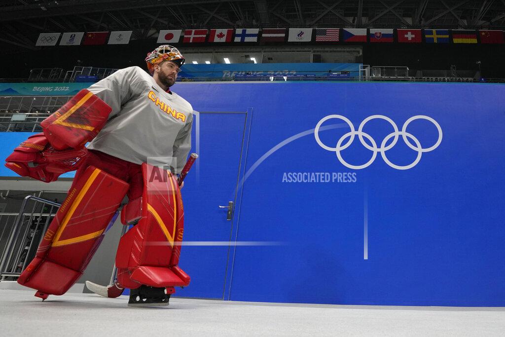 Petr David Josek China goaltender Jeremy Smith enters the arena to attend a men's hockey practice session at the 2022 Winter Olympics, Sunday, Jan. 30, 2022, in Beijing. (AP Photo/Petr David Josek)