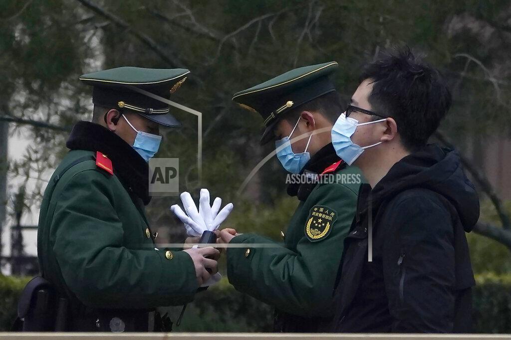 Ng Han Guan Chinese paramilitary policemen change shifts on the streets of Beijing near the Great Hall of the People Wednesday, March 3, 2021. In a sign of confidence China has reverted back to holding its annual Congress meetings to march this year after delaying them due to the outbreak of the coronavirus last year. As usual, security has been tightened in the capital with paramilitary troops patrolling near the Great Hall of the People where the meetings are held and standing guard at subway stations. (AP Photo/Ng Han Guan)