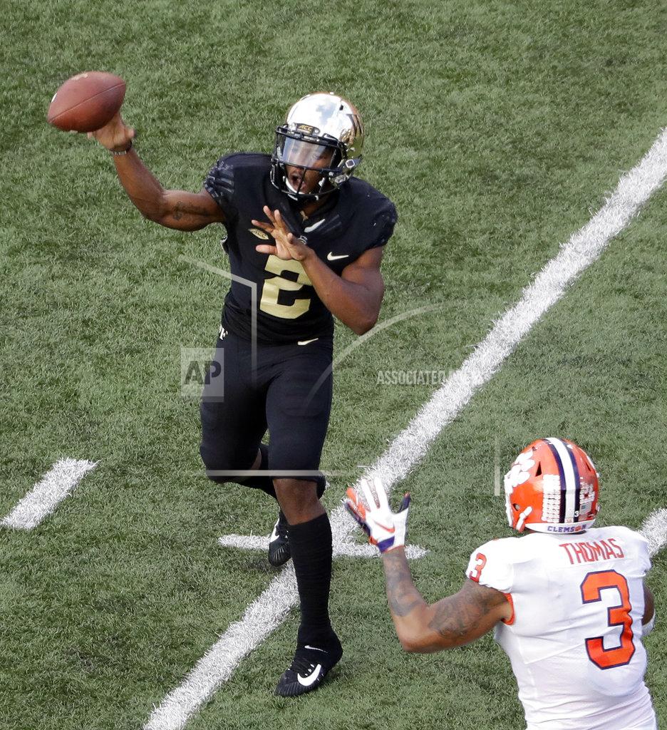 Chuck Burton Wake Forest's Kendall Hinton (2) throws a pass under pressure from Clemson's Xavier Thomas (3) during the second half of an NCAA college football game in Charlotte, N.C., Saturday, Oct. 6, 2018. (AP Photo/Chuck Burton)