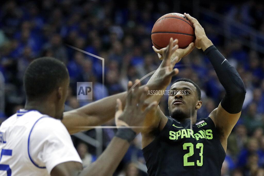 Adam Hunger Michigan State forward Xavier Tillman (23) shoots over Seton Hall center Romaro Gill during the first half of an NCAA college basketball game Thursday, Nov. 14, 2019, in Newark, N.J. (AP Photo/Adam Hunger)