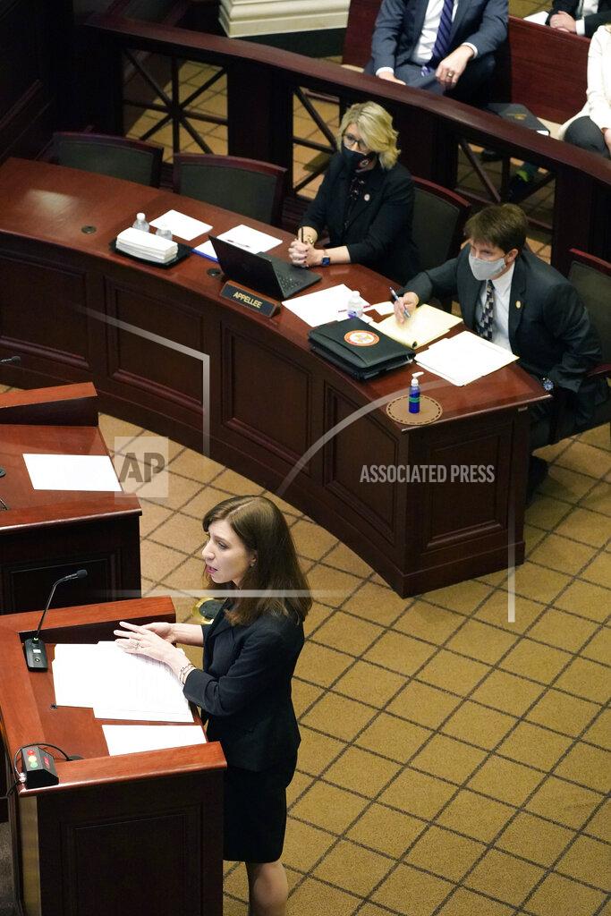 Rogelio V. Solis Attorney Kaytie Pickett, left, argues before the Mississippi Supreme Court, Wednesday, April 14, 2021, in Jackson, on behalf of Madison Mayor Mary Hawkins Butler's lawsuit challenging a medical marijuana initiative by saying because Mississippi's initiative process is outdated and the issue should not have been on the ballot because of the way signatures were gathered. Justin Matheny, right, and Krissy Nobile with the Mississippi attorney general's office, provided the defense of Mississippi's initiative process. Voters approved the medical marijuana initiative in November 2020. (AP Photo/Rogelio V. Solis)