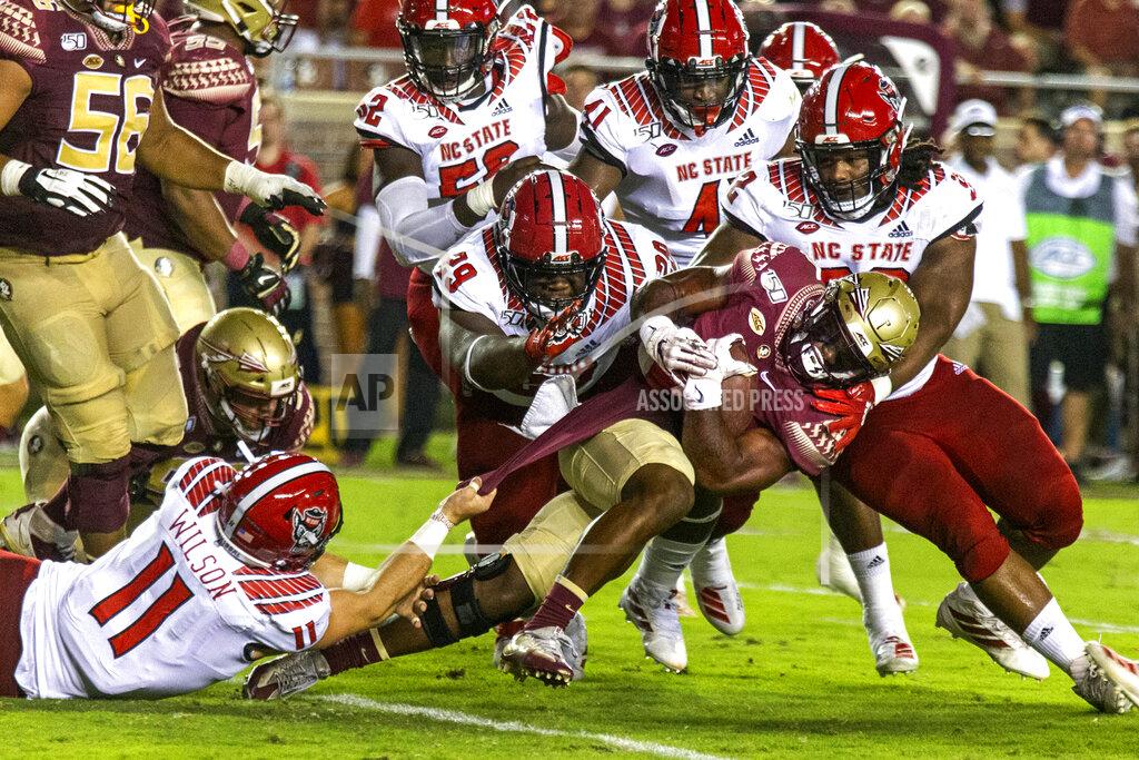 Mark Wallheiser Florida State running back Khalan Laborn (4) charges ahead as he's brought down by North Carolina State linebacker Payton Wilson (11), defensive tackle Alim McNeill (29) and defensive tackle Larrell Murchison (92) in the first half of an NCAA college football game in Tallahassee, Fla., Saturday, Sept. 28, 2019. (AP Photo/Mark Wallheiser)