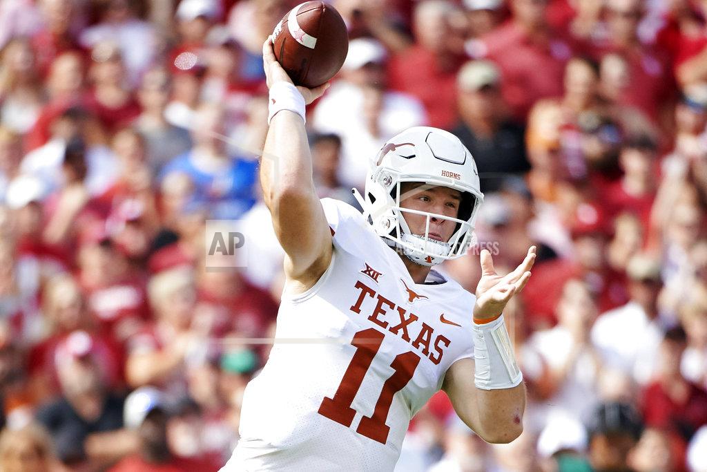 Cooper Neill FILE - In this Oct. 6, 2018, file photo, Texas quarterback Sam Ehlinger (11) throws a pass against Oklahoma during the first half of an NCAA college football game at the Cotton Bowl in Dallas. The Longhorns face Oklahoma in the Big 12 championship game on Saturday. (AP Photo/Cooper Neill, File)
