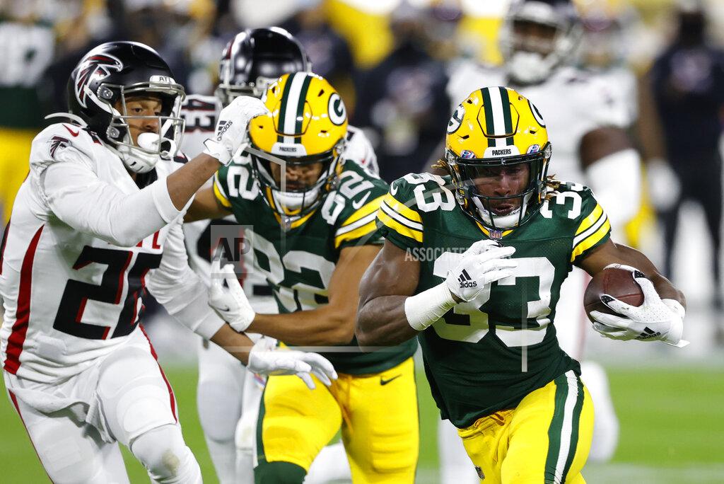 Tom Lynn Green Bay Packers' Aaron Jones (33) is chased by Atlanta Falcons' Isaiah Oliver (26) during the first half of an NFL football game, Monday, Oct. 5, 2020, in Green Bay, Wis. (AP Photo/Tom Lynn)
