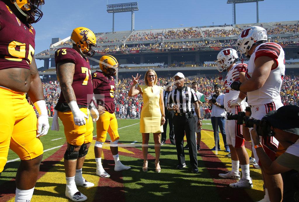 Rick Scuteri Democratic U.S. Senate candidate Kyrsten Sinema gestures before performing the coin toss before an NCAA college football game between Arizona State and Utah, Saturday, Nov 3, 2018, in Tempe, Ariz. (AP Photo/Rick Scuteri)