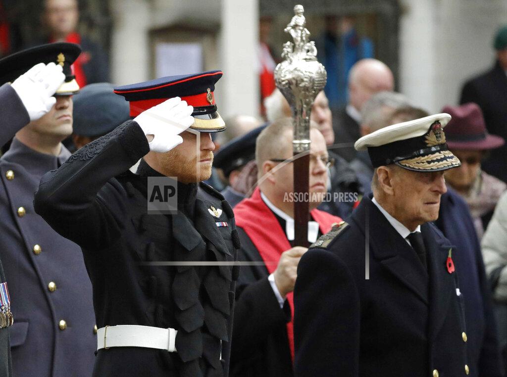Matt Dunham FILE - In this file photo dated Thursday, Nov. 10, 2016, Britain's Prince Harry salutes as he and Prince Philip attend the official opening of the annual Field of Remembrance at Westminster Abbey in London. In the TV program ‘Prince Philip: The Royal Family Remembers’ released late Saturday Sept. 18, 2021, members of the royal family spoke admiringly of the late Duke of Edinburgh’s barbecuing skills and Prince Harry described how his grandfather would “never probe” but listen intently about his two tour of duties to Helmand province during the war in Afghanistan.(AP Photo/Matt Dunham)