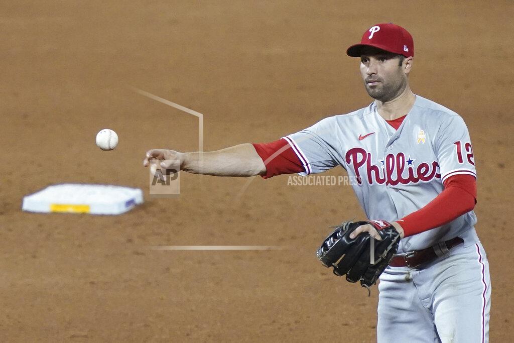 John Minchillo Philadelphia Phillies second baseman Neil Walker throws to first after fielding a ground ball hit by New York Mets' Brandon Nimmo during the third inning of a baseball game, Saturday, Sept. 5, 2020, in New York. Nimmo was out at first. (AP Photo/John Minchillo)